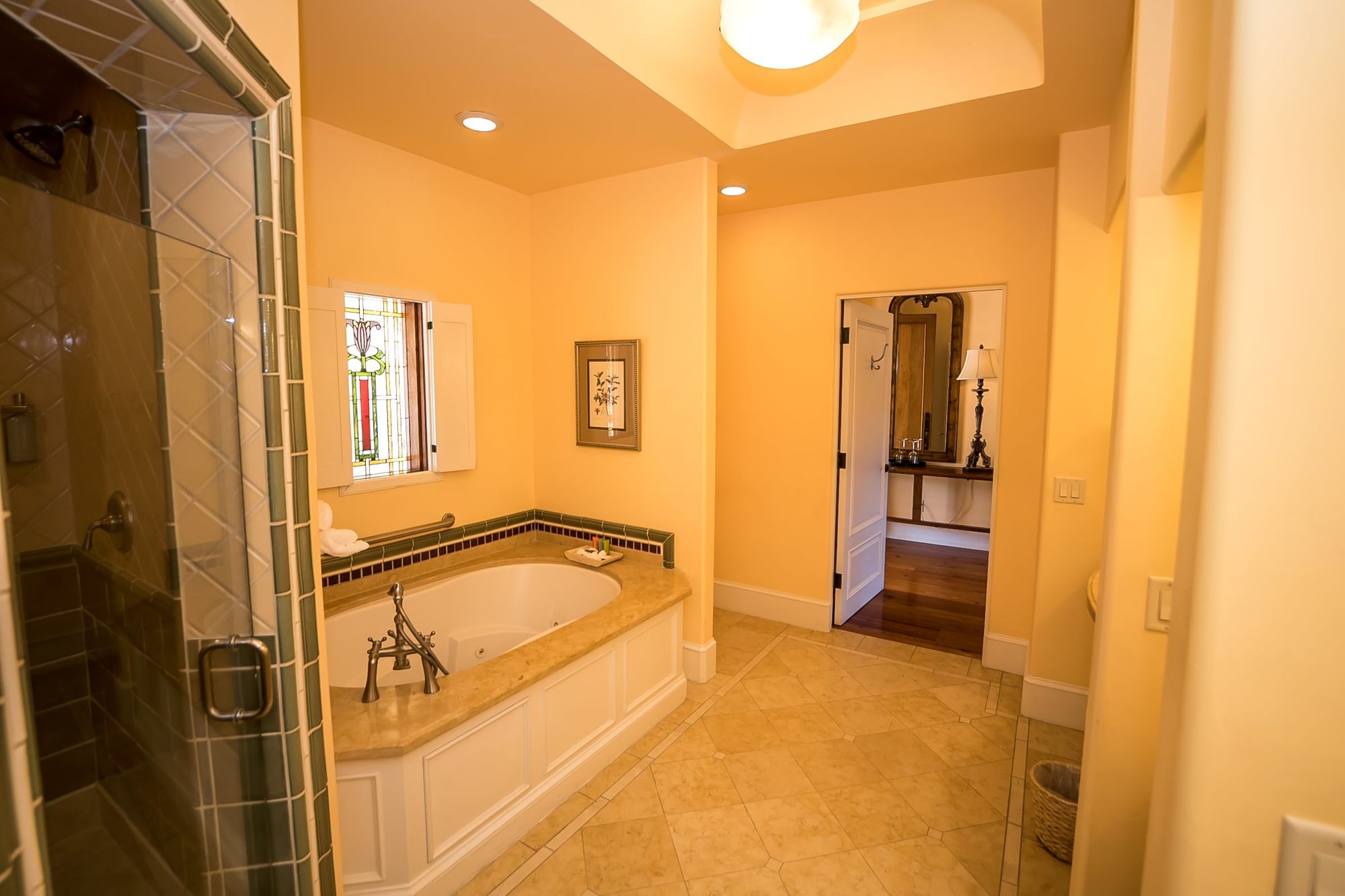 Hall with bathtub to the left and door to hallway at the end