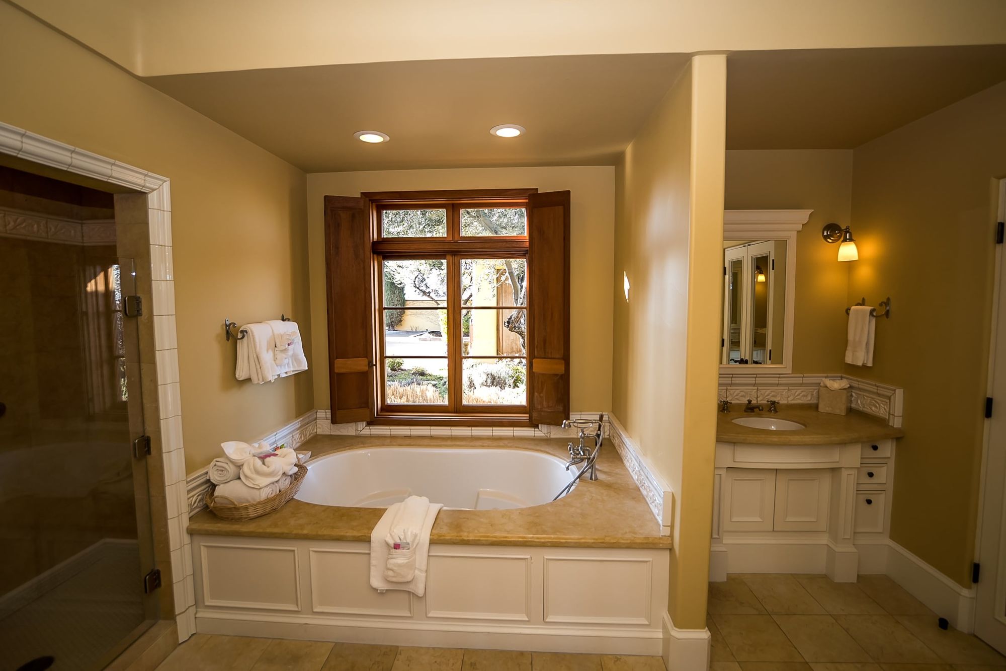 Bathroom with spa tub and towels in a basket with a vanity to the left